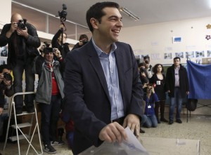 Opposition leader and head of radical leftist Syriza party Tsipras smiles before casting his ballot at a polling station in Athens